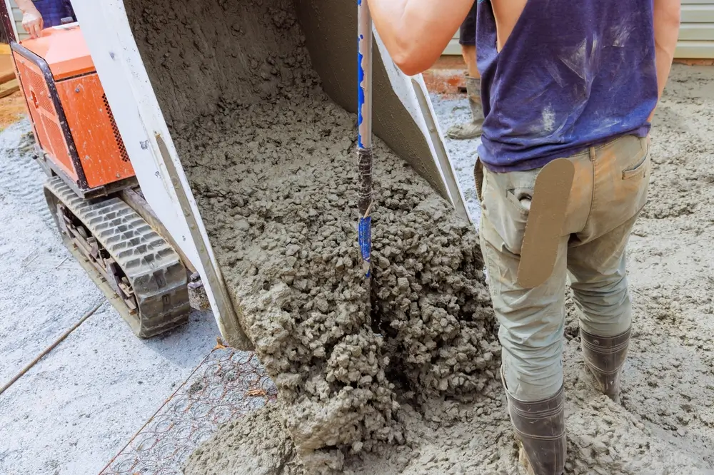 Professional licensed concrete contractor standing in front of a ready-mix concrete truck in Minnesota.